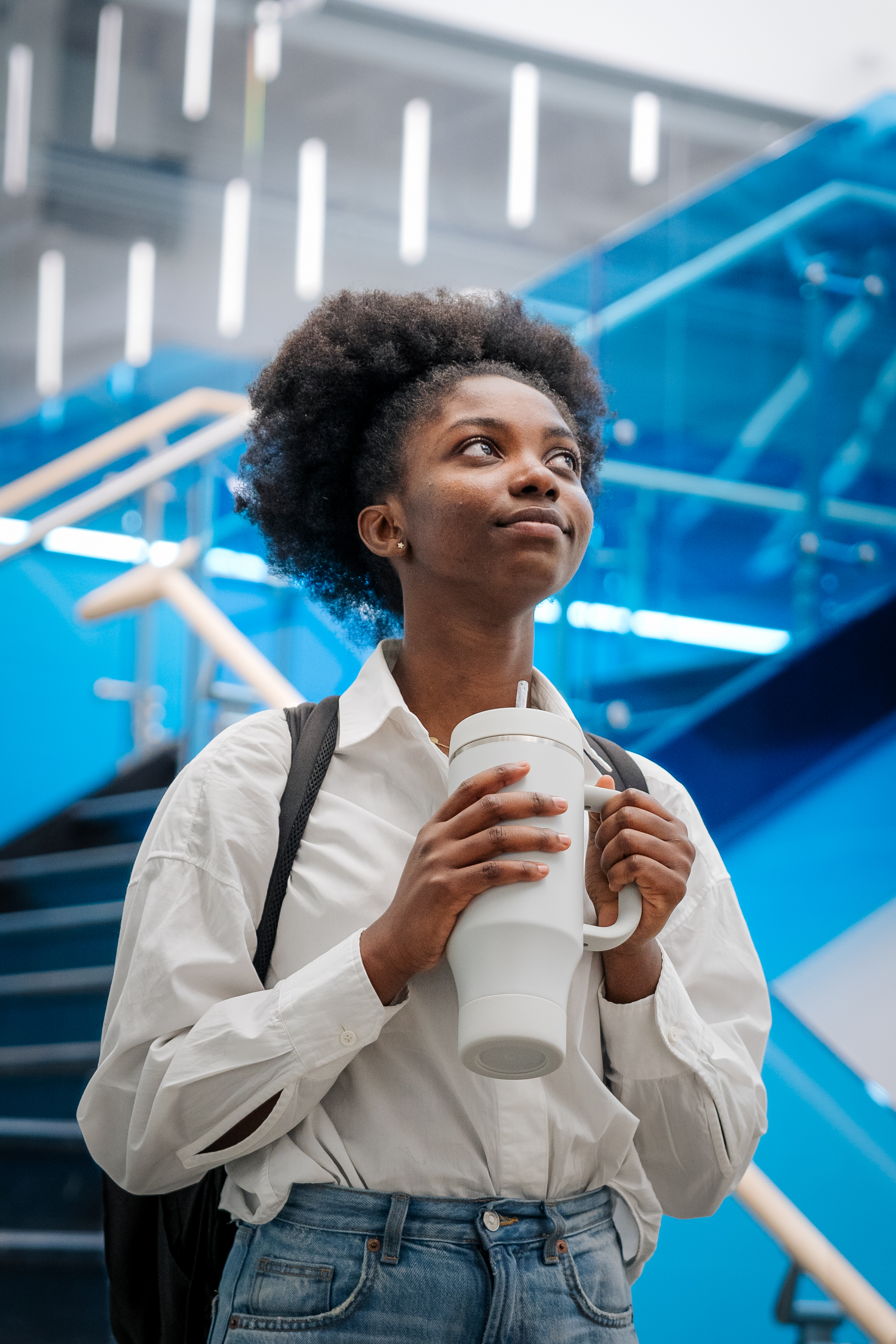Student standing in a modern school setting